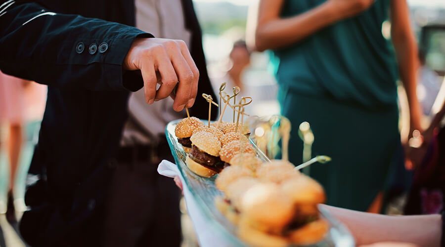 waiter giving out burgers on platter